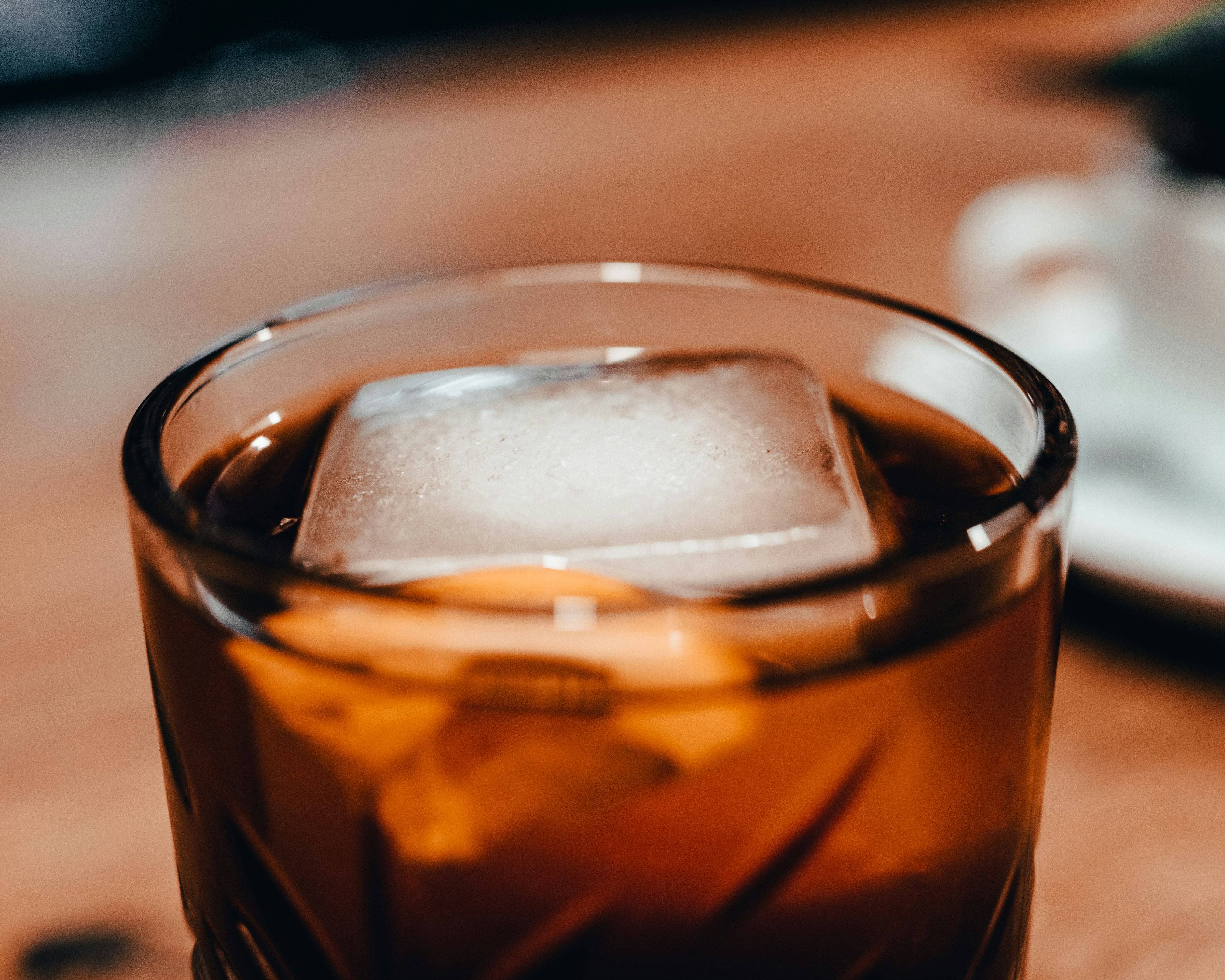 clear drinking glass with brown liquid